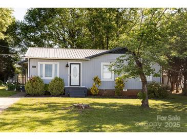 Charming single-story home with mature trees, tidy landscaping, and a light gray exterior at 5014 Oxford School Rd, Claremont, NC 28610