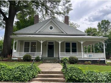 Charming home featuring a large, inviting front porch and well-maintained landscaping at 531 Walnut St, Statesville, NC 28677