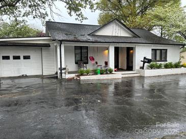 Charming brick home features a covered porch and attached garage at 713 Sloop Ave, Kannapolis, NC 28083