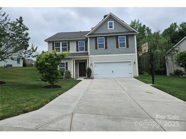Charming two-story home with a landscaped yard, a long driveway, and a basketball hoop at 1071 Bassett Way, Fort Mill, SC 29707