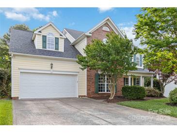 Charming two-story home with a well-manicured front yard and attached two-car garage at 1308 Pennington Nw Pl, Concord, NC 28027