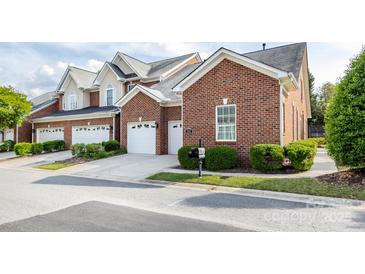 Charming brick home boasts a two-car garage and well-manicured landscaping, enhancing curb appeal at 140 Villa Lake Dr, Fort Mill, SC 29708