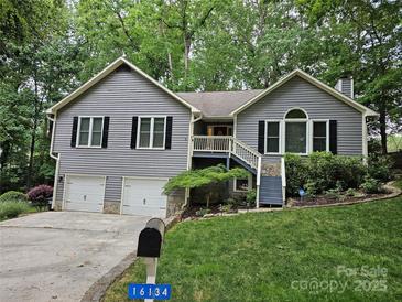 Inviting home with a two-car garage, landscaped yard, and charming front porch stairs at 16134 Tinura Ct # 134, Tega Cay, SC 29708