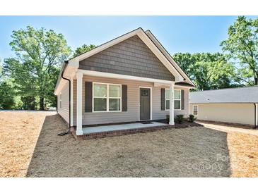 Charming single-story home featuring a covered front porch and a mix of vinyl and shingle siding at 2506 Glendale Ave, Kannapolis, NC 28081
