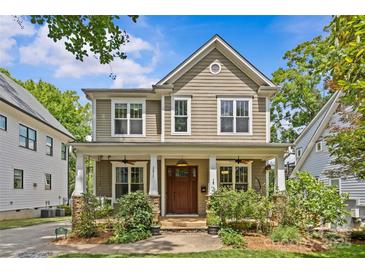 Charming two-story home with a welcoming front porch, manicured landscaping, and classic architectural details at 2617 Bay St, Charlotte, NC 28205