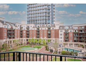 Beautiful courtyard view with pool and gazebo, surrounded by multi-story residences at 300 W 5Th St # 404, Charlotte, NC 28202