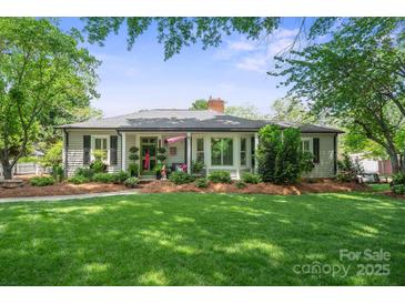 Charming home featuring a lush front yard and inviting curb appeal with landscaped garden beds and a cozy front porch at 404 N Laurel St, Lincolnton, NC 28092