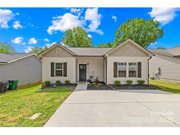 Charming single-story home with a well-manicured lawn, concrete driveway, and welcoming front entrance at 5648 Woodard St, Charlotte, NC 28269