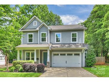 Charming two-story home features a blue front door, grey siding, and a well-maintained lawn at 1209 Leigh Ave, Charlotte, NC 28205