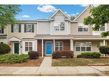 Charming townhome featuring a bright blue front door and well-maintained landscaping at 13660 Meade Glen Ct, Charlotte, NC 28273