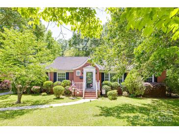 Charming brick home with lush landscaping and inviting front porch, perfect for enjoying the outdoors at 308 Gillsbrook Rd, Lancaster, SC 29720
