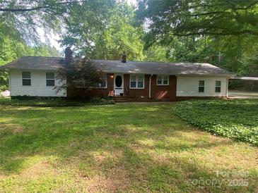 Charming single story home featuring a brick facade and covered carport at 3933 Planters Pl, Indian Trail, NC 28079