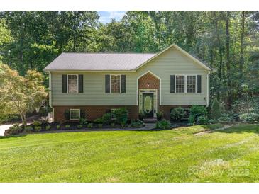 Charming two-story home with green lawn and mature trees at 4700 Hickory Grove Rd, Mount Holly, NC 28120