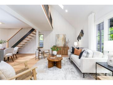Bright living room boasts vaulted ceiling, natural light, and modern decor at 6501 Piney Path Rd, Charlotte, NC 28212