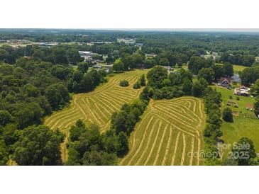 An aerial view of a vast lot with partially cleared land and trees around its perimeter at 1040 Nc 90 W Hwy, Taylorsville, NC 20681