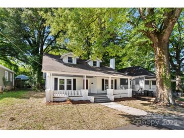 Charming one-story home with dormer windows and a welcoming front porch surrounded by mature trees and ample space at 115 W 5Th Ave, Gastonia, NC 28052