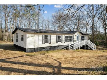 Charming home with white siding, black trim and a welcoming entrance staircase at 137 S Penny St, Lancaster, SC 29720
