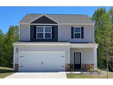 Two story home featuring a two-car garage, gray siding, and a manicured lawn at 1542 Doran Ter, Richburg, SC 29729