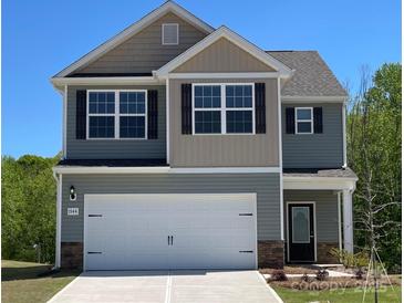 Charming two-story home features a two-car garage, a mix of stone and siding, and a well-manicured lawn at 1544 Doran Ter, Richburg, SC 29729