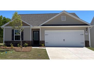 Charming single-story home featuring a two-car garage, stone accents, and neutral siding for a modern look at 1550 Doran Ter, Richburg, SC 29729