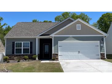 Charming single-story home with a two-car garage, gray siding, and a well-manicured lawn at 1550 Doran Ter, Richburg, SC 29729