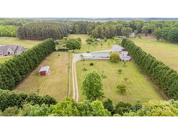 Expansive aerial view of a home, showcasing its large lawn, outbuildings, surrounding trees, and a long driveway at 1720 Lowe Dr, Catawba, NC 28609