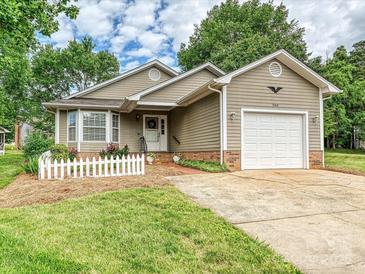 Charming single-Gathering home with a well-manicured lawn, attached garage and inviting curb appeal at 2919 Peachwood Ct, Fort Mill, SC 29715
