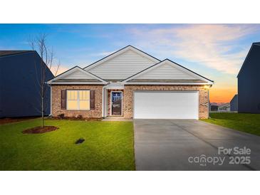 Charming brick home featuring an attached two-car garage, well-maintained lawn, and inviting front entrance at 3662 Charles Nw St, Conover, NC 28613