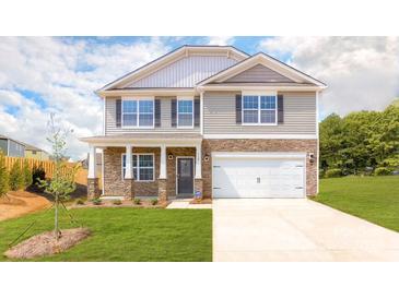 Charming two-story home featuring stone accents, a two-car garage, and a well-manicured lawn at 3948 Ashton Nw Dr, Conover, NC 28613