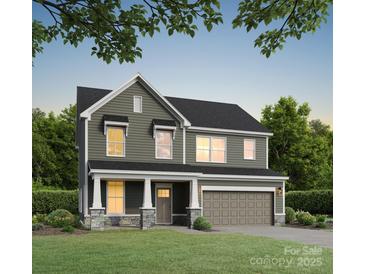 Charming two-story home with a welcoming front porch and attached two-car garage at 5112 Izzo Ln, Charlotte, NC 28214