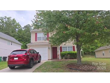 Charming two-story home with a well-maintained lawn and a red Mazda parked in the driveway at 632 Pawley Dr, Charlotte, NC 28214