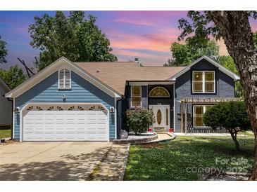Charming two-story home with a two-car garage, landscaped yard, and inviting front entrance at 7218 Jacobs Fork Ln, Charlotte, NC 28273