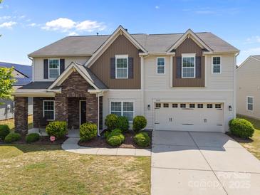 Charming two-story home featuring stone accents, neutral siding, and an attached two-car garage at 13315 Hunting Birds Ln, Charlotte, NC 28278