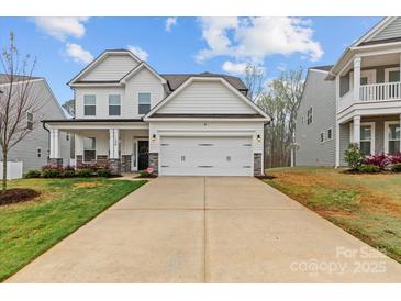 Charming two-story home with a spacious two-car garage and inviting curb appeal with a long driveway at 154 Cotton Field Dr, Statesville, NC 28677