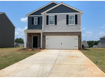 Two-story home featuring a mix of gray siding and brick, a two-car garage, and a concrete driveway at 156 Parker Claire Ln, Kings Mountain, NC 28086