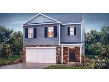 Charming two-story home featuring stone accents, gray siding, and a well-maintained front yard at 222 Giant Oak Ave, Statesville, NC 28677