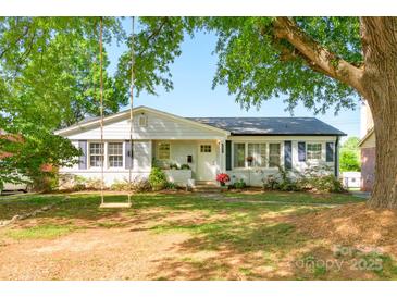 Charming single-story home with a well-maintained front yard and mature trees at 4838 Holbrook Dr, Charlotte, NC 28212