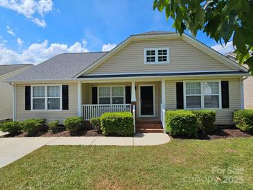 Charming single-story home with a well-manicured lawn and inviting front porch, perfect for relaxation at 5018 Drake Pond Ln, Rock Hill, SC 29732