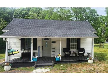 Charming single-story home featuring a welcoming front porch with swing and dark-stained wood flooring at 642 Boger St, Mooresville, NC 28115