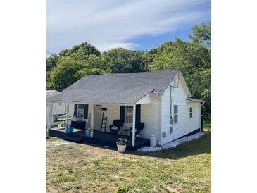 Charming exterior of a bright white one story home with a cozy front porch and well manicured yard at 642 Boger St, Mooresville, NC 28115