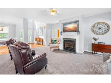 Bright living room featuring a fireplace with mounted TV and comfortable seating at 1305 Glenview Ln, Rock Hill, SC 29730