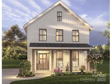 Charming two-story modern farmhouse with inviting front porch and beautiful landscaping at 1427 Rankin Ave, Gastonia, NC 28052