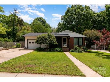 Charming single-story home with well-maintained lawn, mature trees, and attached garage at 1509 Wiltshire Rd, Salisbury, NC 21844
