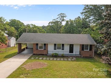 Charming single-story home featuring a cozy carport, brick accents and well-maintained landscaping at 322 S Vine St, Gastonia, NC 28052