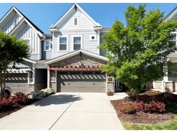 Charming home featuring a two-car garage, stone accents, and a well-manicured front yard with mature landscaping at 432 Belton St, Charlotte, NC 28209