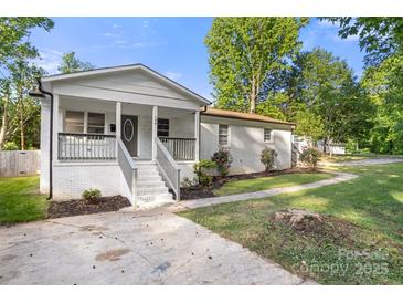Charming white brick home with a welcoming front porch and well-maintained landscaping at 104 Berry St, Fort Mill, SC 29715