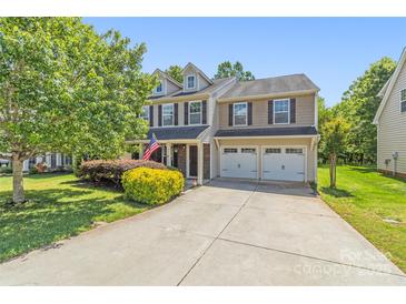 Charming two-story home with a well-manicured lawn and two-car garage at 111 Tilton Dr, Mooresville, NC 28115