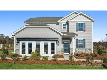 Charming two-story home with gray siding, dark shutters, and a welcoming front entrance with tasteful landscaping at 1113 Hallman Branch Ln, Lincolnton, NC 28092