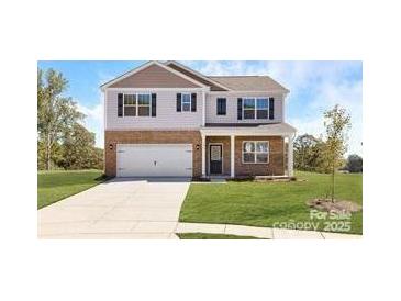 Charming two-story home featuring a brick-and-siding exterior, a well-manicured lawn, and a concrete driveway at 113 Way Cross Ln, Troutman, NC 28166