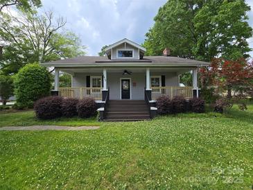 Charming single story home featuring a covered front porch, landscaped yard, and freshly painted siding at 1415 S York Rd, Gastonia, NC 28052